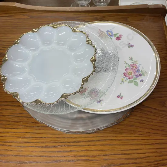 Assortment of round glass and china Platters with milk glass egg tray