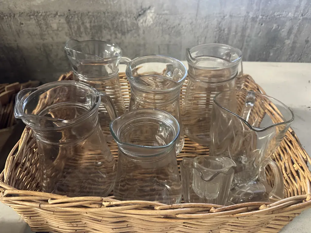 Cane Basket With Assorted Glass Pitchers & Jugs Image 1++