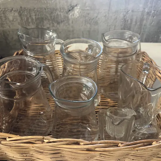 Cane Basket With Assorted Glass Pitchers & Jugs
