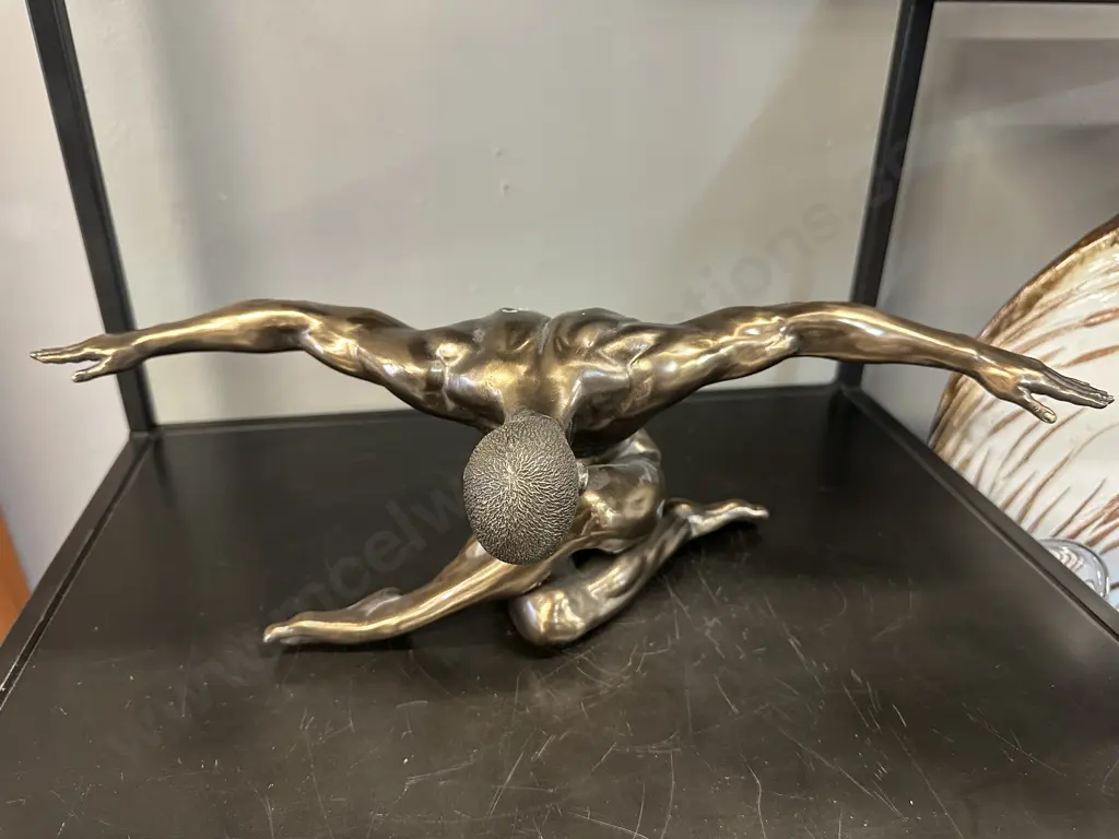 Bronze Coloured Sculpture Of A Male Figurine With Outstretched Arms Image 1++