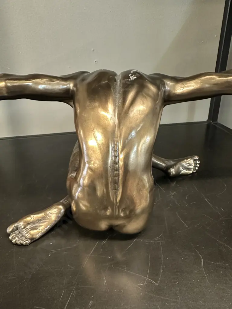 Bronze Coloured Sculpture Of A Male Figurine With Outstretched Arms Image 1++