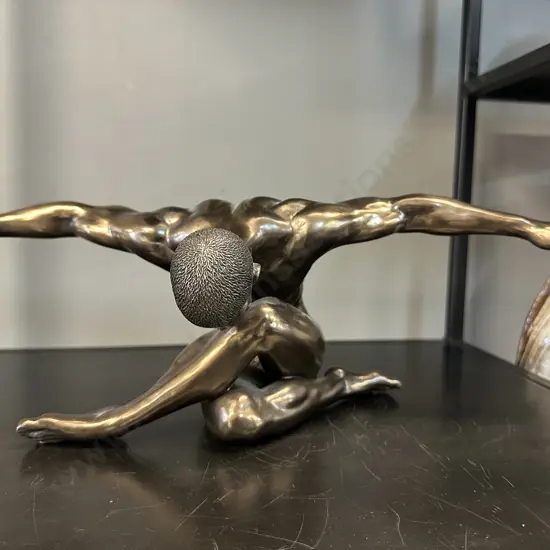 Bronze Coloured Sculpture Of A Male Figurine With Outstretched Arms