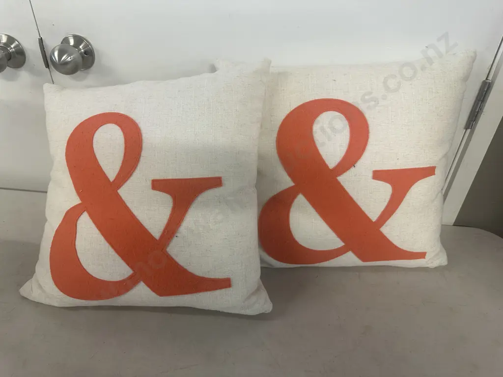 Pair Of Designer Cushions Cream Linen With Large Orange Symbol Image 1++