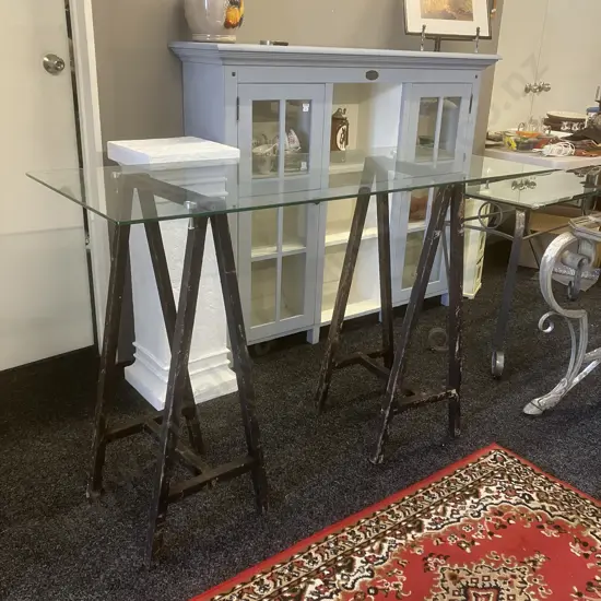 Glass Top Table On a Pair of Black Steel Trestles. H92.5 W140 D60cm