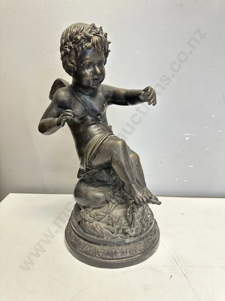Spelter Sculpture Depicting A Winged Cupid Sitting On A Rock H33cm. Image 1++