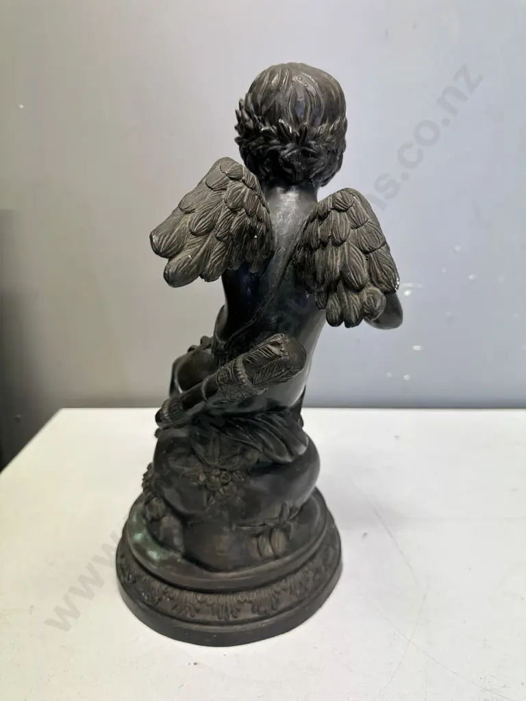 Spelter Sculpture Depicting A Winged Cupid Sitting On A Rock H33cm. Image 1++