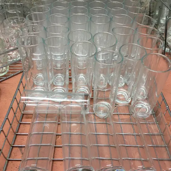 Two Trays Of Tall Glasses In Steel Trays