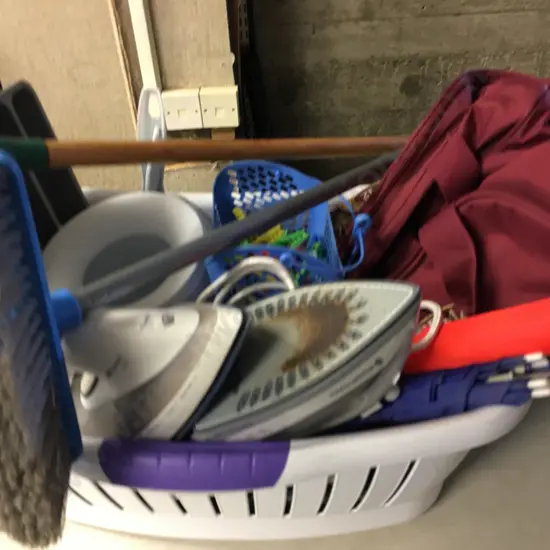 Laundry Hamper With Assorted Items Including Brooms, Umbrellas, Irons Etc