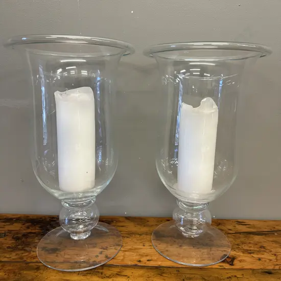 Pair of Tall Footed Hurricane Glass Candle Holders With White Candles. 45 x 26cm