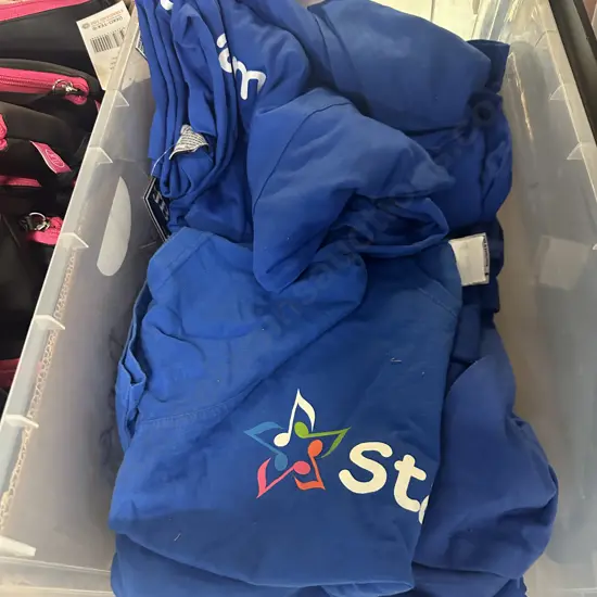 Clear Bin Of Blue Tee Shirts Including New Assorted Sizes