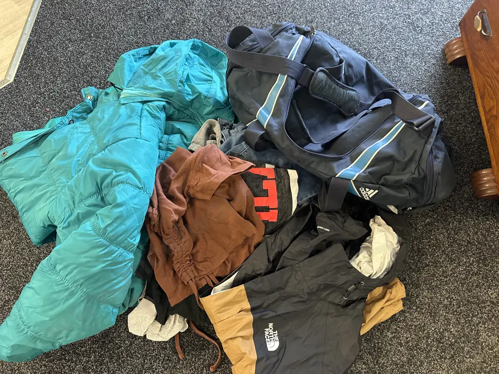Green Puffer Jacket, North Face Jacket, Assorted Clothing & Blue Duffel Bag Image 1++