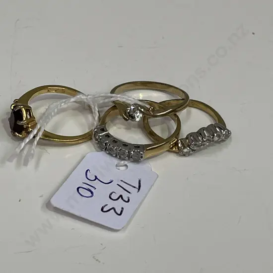 Four gold coloured rings with assorted stones. Some stamped