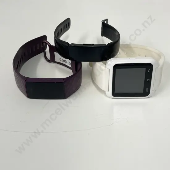 Purple Fitbit Watch with two other watches