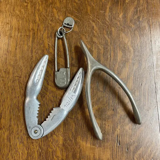 Vintage Collectable Metal Items. Military Laundry idenification pin, nut cracker and wish bone